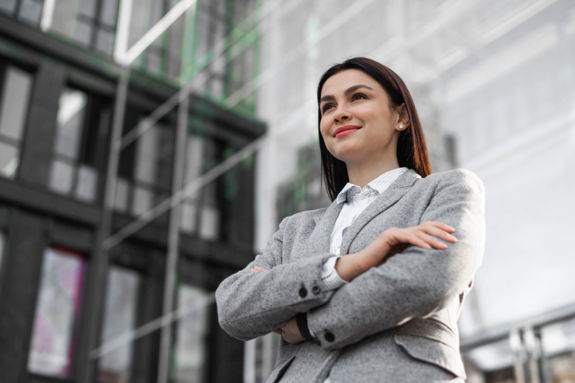 low-angle-businesswoman-posing-with-arms-crossed-city.jpg